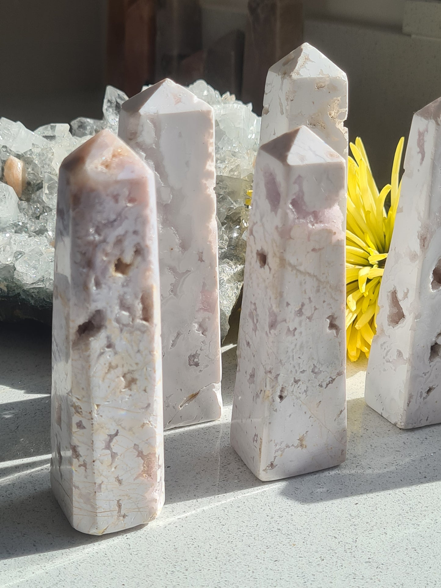 Crystalline Snow White Agate Obelisks, pictured in natural daylight showing their sparkling druzy caves and natural features.